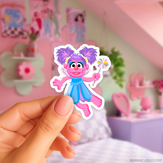 Add some fun with this Abby sticker! Perfect for party favors, crafts, or decorating notebooks, laptops, and more — the best gift for Sesame Street fans.